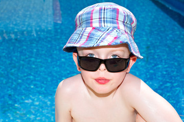 little boy oiled up with sun cream