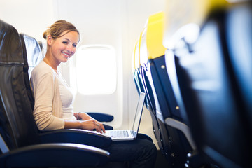 Young woman on board of an airplane