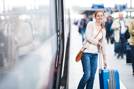 Pretty young woman boarding a train