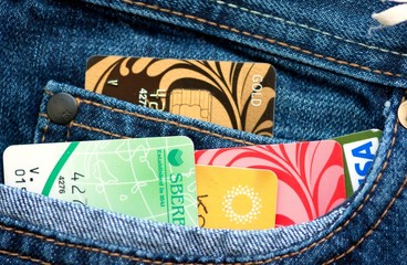 Multicolored credit cards in the pocket of jeans.