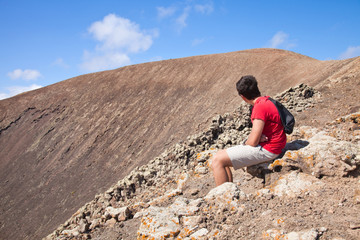 Fototapeta premium teenage boy resting, hike up the caldera