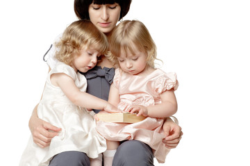 Mother playing with her daughters twins in her laps