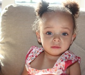 Pretty Blue eyed ethnic baby girl with bunches