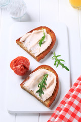Crispy bread with spread and salami