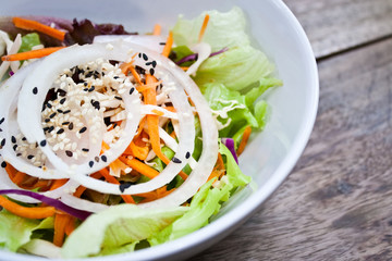 a bowl of fresh vegetable salad,side dish, onion,cabbage,carot,s