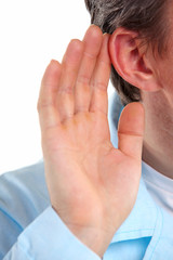 Listening: closeup view of male hand on his ear