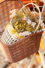 Artificial flower in bicycle basket © Sura Nualpradid