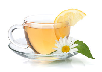Cup of tea with lemon slice, mint leaves and chamomile flower