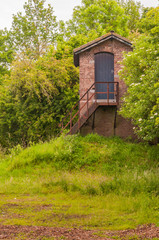 Fototapeta na wymiar Typical small house between trees