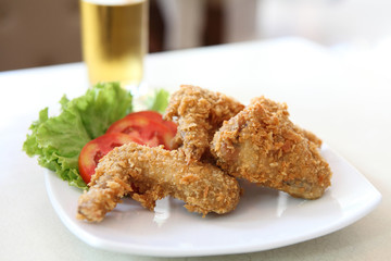 Fried Chicken with tomato vegetable and beer