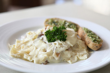 Farfalle pasta with white sauce and bacon