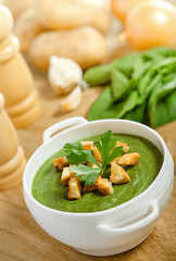 Cream soup with dried crusts and ingridients on the table