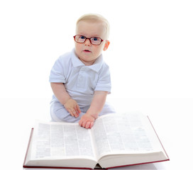 Little boy reads a big book