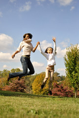 Mother and daughter jump together
