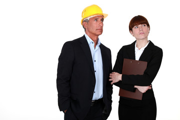 real estate businessman and assistant looking at something