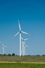 Fototapeta premium Wind turbine farm on rural terrain