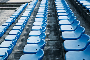 Obraz premium blue ordered rubber seats in a sports track field