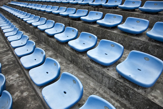 blue ordered rubber seats in a track field