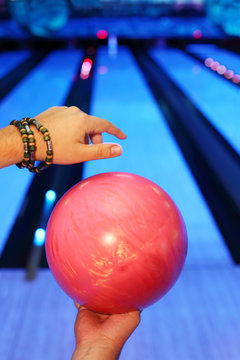 Hands of man, which holds ball and prepares to throw in bowling