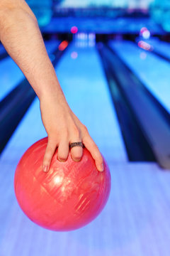 Hands of man, which holds ball and prepares to throw in bowling