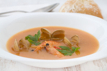 soup with seafood in white plate