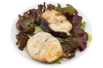 grilled fish with salad on the white plate