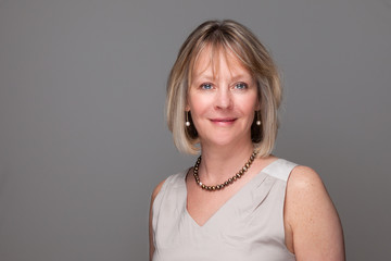 Head Shot of Attractive Smiling Elegant Woman on Grey Background
