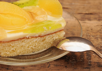 Close-up  of apricot cake on glass plate on wooden table