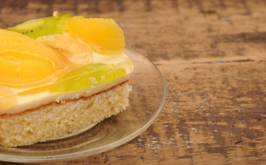 Close-up  of apricot cake on glass plate on wooden table