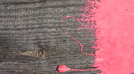 pink paint on old wooden background