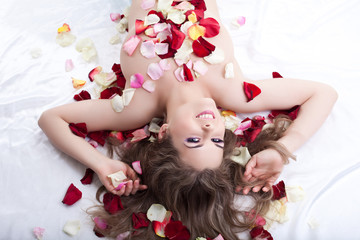 Young woman in rose petals