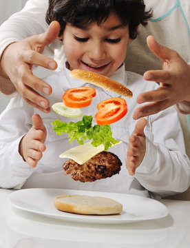 Mother and little boy with burger in hands