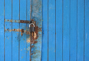 The padlock locking the wooden door
