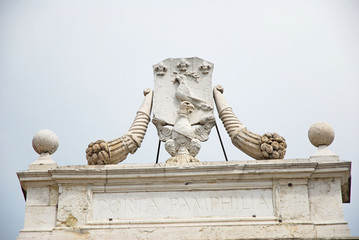 Ravenna,medieval city door Porta Pamphilia Pope symbols.
