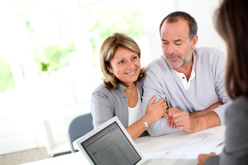 Senior couple ready to buy new house reading contract