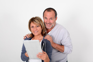Senior couple having fun with electronic tablet