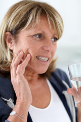 Closeup of senior woman having toothache - obrazy, fototapety, plakaty