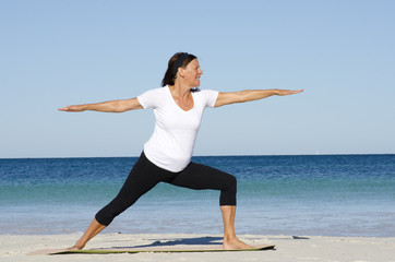 Mature woman exercising at beach