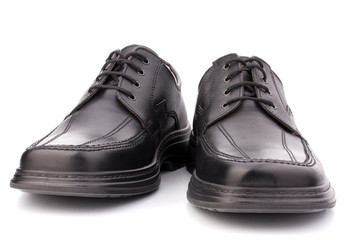 Black glossy man’s shoes with shoelaces