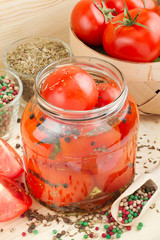 Homemade tomatoes preserves in glass jar. Canned tomatoes.