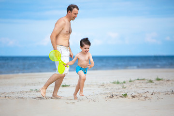 Happy father and son on the beach.