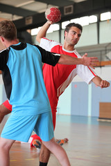 Man throwing ball during handball game