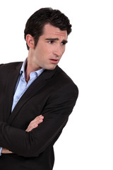 Businessman with his arms folded in disbelief