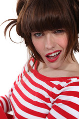 brunette wearing red and white striped shirt making grimace