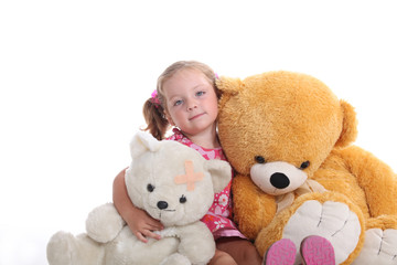 Little girl sat with cuddly toys