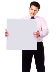 Businessman holding a blank, isolated on white background