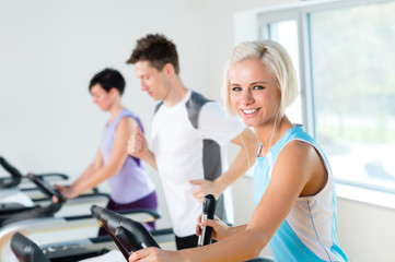 Fototapeta na wymiar Fitness young people on treadmill running exercise