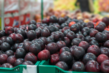 Variety of nectarines in boxes in supermarket