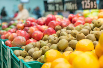 Variety of kiwi fruits and pomegranate fruits in boxes in superm