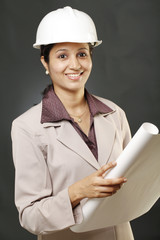 Young female architect with blue print